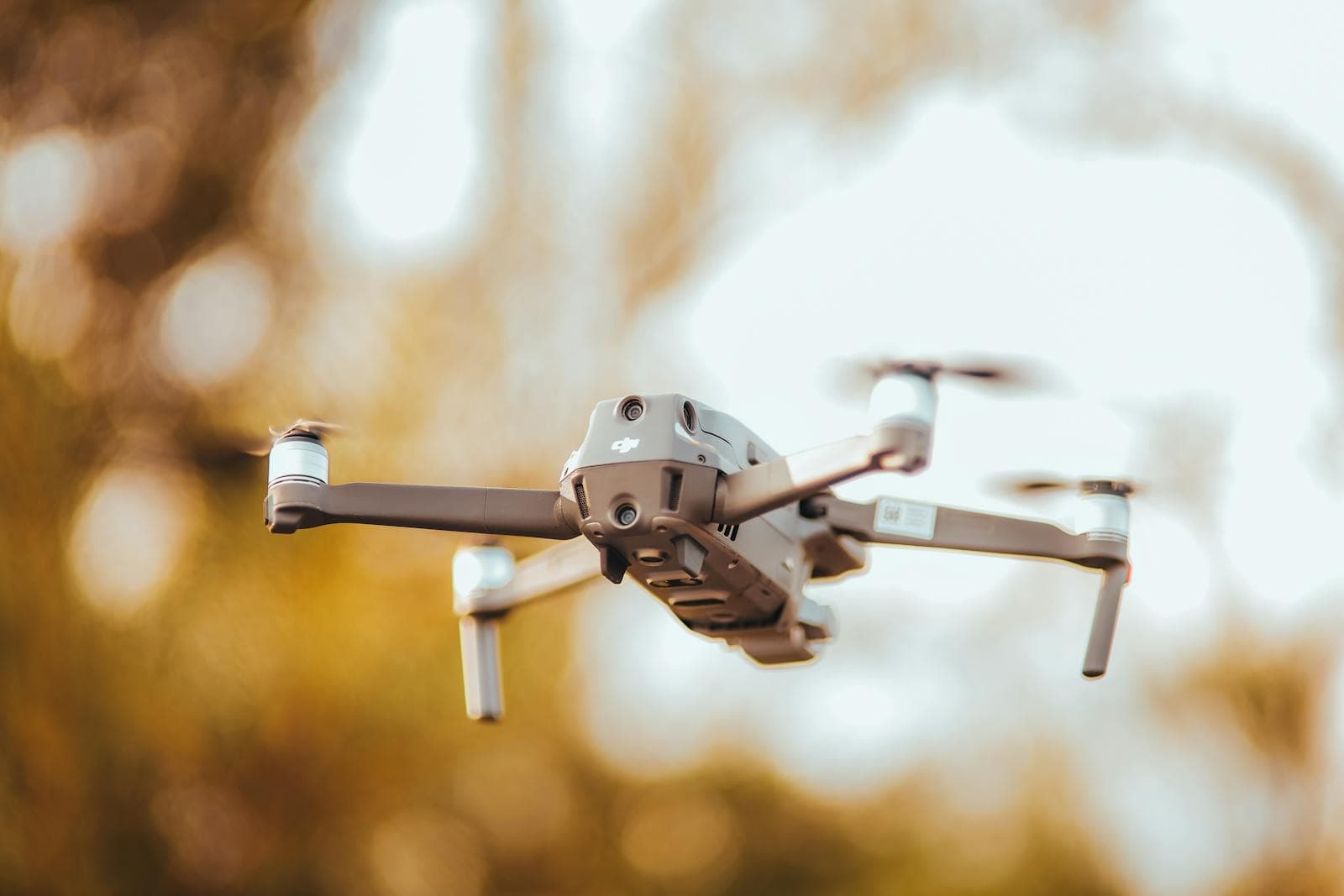 Modern DJI Mavic-style drone flying during an aerial property inspection